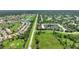 Aerial view of a townhouse community with a pond and mature trees at 4790 Turnberry Cir, North Port, FL 34288