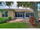 View of the backyard patio, screened in lanai, and lush landscaping at 4790 Turnberry Cir, North Port, FL 34288