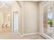 Bright and airy foyer with tile flooring, and view of a half bathroom and french door at 4790 Turnberry Cir, North Port, FL 34288