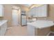 Eat-in kitchen with white appliances, ample cabinet space, and a breakfast bar at 4790 Turnberry Cir, North Port, FL 34288