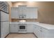 Well-lit kitchen with white cabinetry, modern appliances, and tile flooring at 4790 Turnberry Cir, North Port, FL 34288