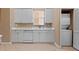 Laundry area features washer, dryer, utility sink and plenty of white cabinets at 4790 Turnberry Cir, North Port, FL 34288