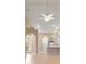 Spacious living room features a ceiling fan and tile flooring that extends into the kitchen area at 4790 Turnberry Cir, North Port, FL 34288