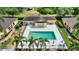Aerial view of a community pool with patio furniture and palm trees at 4790 Turnberry Cir, North Port, FL 34288