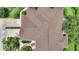 Aerial view of roof surrounded by lush landscaping, greenery, and a brick driveway at 4790 Turnberry Cir, North Port, FL 34288
