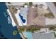 Aerial view of a home with backyard pool, dock, and waterfront access on a canal at 507 59Th St, Holmes Beach, FL 34217
