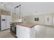 Kitchen island with electric cooktop, white cabinets, and white refrigerator at 507 59Th St, Holmes Beach, FL 34217