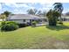 Beautiful backyard featuring an enclosed pool and lush greenery at 5111 Canterbury Dr, Sarasota, FL 34243