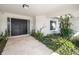 Front entrance featuring a tiled walkway, a double door, and tropical landscaping at 5111 Canterbury Dr, Sarasota, FL 34243