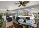 Covered patio with ceiling fans, outdoor dining and sitting areas overlooking the pool at 5111 Canterbury Dr, Sarasota, FL 34243