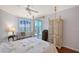 Bright bedroom with a four-poster bed with access to a private balcony at 5420 Eagles Point Cir # 106, Sarasota, FL 34231