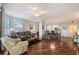 Bright living room with hardwood floors, floral sofa, plantation shutters and ceiling fan at 5420 Eagles Point Cir # 106, Sarasota, FL 34231