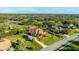 Beautiful aerial shot of a suburban home with a lush lawn, mature trees, and a view of nearby lakes and green spaces at 6107 Glen Abbey Ln, Bradenton, FL 34202