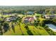 Aerial view of a home with a screened lanai and lush, green landscaping close to community tennis and a beautiful lawn at 6107 Glen Abbey Ln, Bradenton, FL 34202