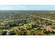Breathtaking aerial shot showcases mature trees surrounding this golf course community. Many houses feature private pools and lush lawns at 6107 Glen Abbey Ln, Bradenton, FL 34202