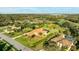 Attractive aerial view of single Gathering home with manicured lawn, mature palm trees, and access to community lakes and green spaces at 6107 Glen Abbey Ln, Bradenton, FL 34202
