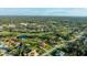 Expansive aerial view showcasing the landscape of the houses in a golf course community with mature trees, lake views, and green spaces at 6107 Glen Abbey Ln, Bradenton, FL 34202