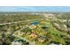 Wide angle aerial view capturing houses in a golf course community with mature trees, lakes, and lush green lawns and landscaping at 6107 Glen Abbey Ln, Bradenton, FL 34202
