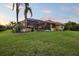 Lush backyard with pool, palm trees, and space for recreation at 6107 Glen Abbey Ln, Bradenton, FL 34202