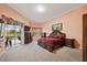 Spacious bedroom with outdoor access, large windows, and a well-appointed dark wood furniture set at 6107 Glen Abbey Ln, Bradenton, FL 34202