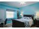 Bright bedroom with a large window, a bed, and a dedicated workspace at 6107 Glen Abbey Ln, Bradenton, FL 34202