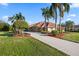 Well-maintained driveway leading to a home with lush landscaping at 6107 Glen Abbey Ln, Bradenton, FL 34202