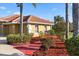 Exterior view of the home featuring mature landscaping and decorative mulch at 6107 Glen Abbey Ln, Bradenton, FL 34202