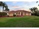 Home's facade with vibrant lawn, manicured landscape, and a tiled roof at 6107 Glen Abbey Ln, Bradenton, FL 34202