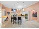 Open kitchen with a center island, stainless steel appliances, breakfast bar, and modern lighting at 6107 Glen Abbey Ln, Bradenton, FL 34202