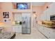 A bright kitchen featuring white cabinets, stainless steel appliances, and granite countertops at 6107 Glen Abbey Ln, Bradenton, FL 34202
