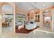 Bright living room with a view of the pool, a fireplace, and an open layout connecting to the dining area at 6107 Glen Abbey Ln, Bradenton, FL 34202