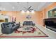 A wide view of the living room with modern furnishings, ceiling fan, and a fireplace at 6107 Glen Abbey Ln, Bradenton, FL 34202