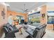 A sunlit living room with comfortable seating and sliding glass doors leading to the pool area at 6107 Glen Abbey Ln, Bradenton, FL 34202