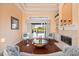 Inviting living room with fireplace, sliding glass doors to the pool area, and stylish decor at 6107 Glen Abbey Ln, Bradenton, FL 34202