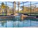 The luxurious pool features a beautiful fountain and lush tropical landscape at 6107 Glen Abbey Ln, Bradenton, FL 34202