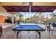 Entertain in this covered pool area with a pool table, outdoor kitchen and expansive patio at 6107 Glen Abbey Ln, Bradenton, FL 34202