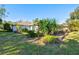 Well-manicured front yard featuring lush landscaping and a charming home exterior at 6929 Arbor Oaks Cir, Bradenton, FL 34209