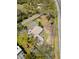 Aerial view of a house with an oversized lot surrounded by mature trees and proximity to major roads at 7018 13Th E Ave, Bradenton, FL 34208
