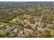 Aerial view of home and its location within a tree-lined neighborhood and along a highway at 7018 13Th E Ave, Bradenton, FL 34208