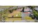 Aerial view of a single story home on a large lot with a driveway, fence and mature trees at 7018 13Th E Ave, Bradenton, FL 34208
