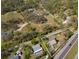 Aerial view showing house with oversized lot in a wooded neighborhood with proximity to major roads at 7018 13Th E Ave, Bradenton, FL 34208