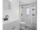 Modern bathroom featuring a glass shower, stylish tile, updated sink, and a fun shower curtain at 7018 13Th E Ave, Bradenton, FL 34208