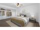 Bright bedroom featuring a ceiling fan, hardwood floors, natural light, and a walk-in closet at 7018 13Th E Ave, Bradenton, FL 34208