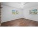Spacious bedroom with hardwood floors and plenty of natural light from the two windows at 7018 13Th E Ave, Bradenton, FL 34208