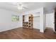 Bright bedroom with hardwood floors, ceiling fan, and a closet with custom shelving for organization at 7018 13Th E Ave, Bradenton, FL 34208
