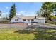 Charming single-story home featuring a gravel driveway, a one car garage, and nicely landscaped front yard at 7018 13Th E Ave, Bradenton, FL 34208
