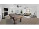 Spacious game room featuring a pool table, hardwood floors, modern furniture, and bright natural light at 7018 13Th E Ave, Bradenton, FL 34208