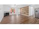 Spacious living room featuring hardwood floors, fireplace, bright natural light, and lots of open space at 7018 13Th E Ave, Bradenton, FL 34208