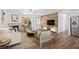 Cozy living room features hardwood floors, modern furniture, fireplace, and a unique wood accent wall at 7018 13Th E Ave, Bradenton, FL 34208