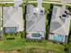 Aerial view of three homes, each with a screened-in pool and well-manicured lawns in a serene neighborhood at 7928 Redonda Loop, Bradenton, FL 34202